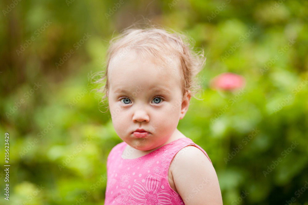 Portrait of cute little girl in summer garden Portrait of cute little girl in summer garden