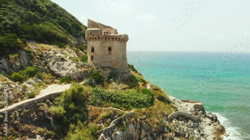 Tower of Paola. It's construction of the Middle Ages times. Sabaudia, Lazio, Italy. Riviera di Ulysses. Aerial drone view to big mountain and turquoise sea water