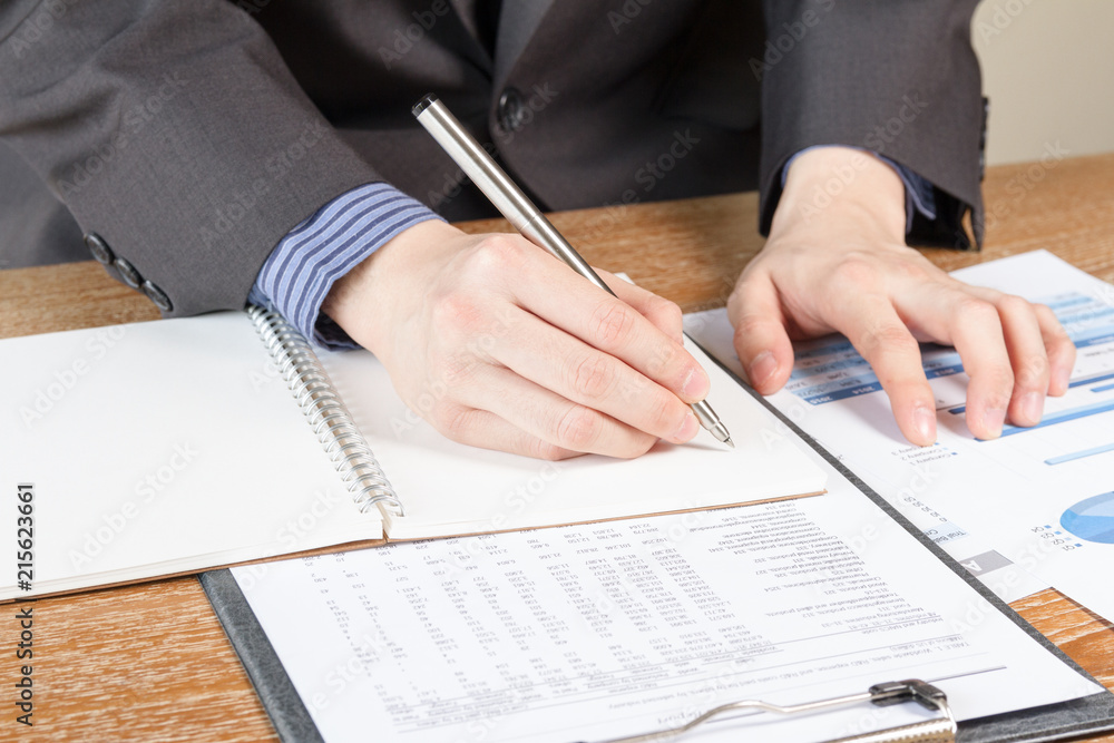 business man analyzing graph and chart document report business man analyzing graph and chart document report