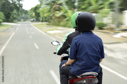 Portrait of motorcycle taxi driver delivering the passenger to his destination