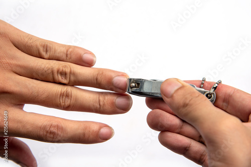 Man hand holding nail scissors to cut manicure.