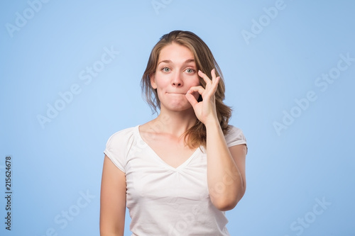 Woman showing shh sign photo