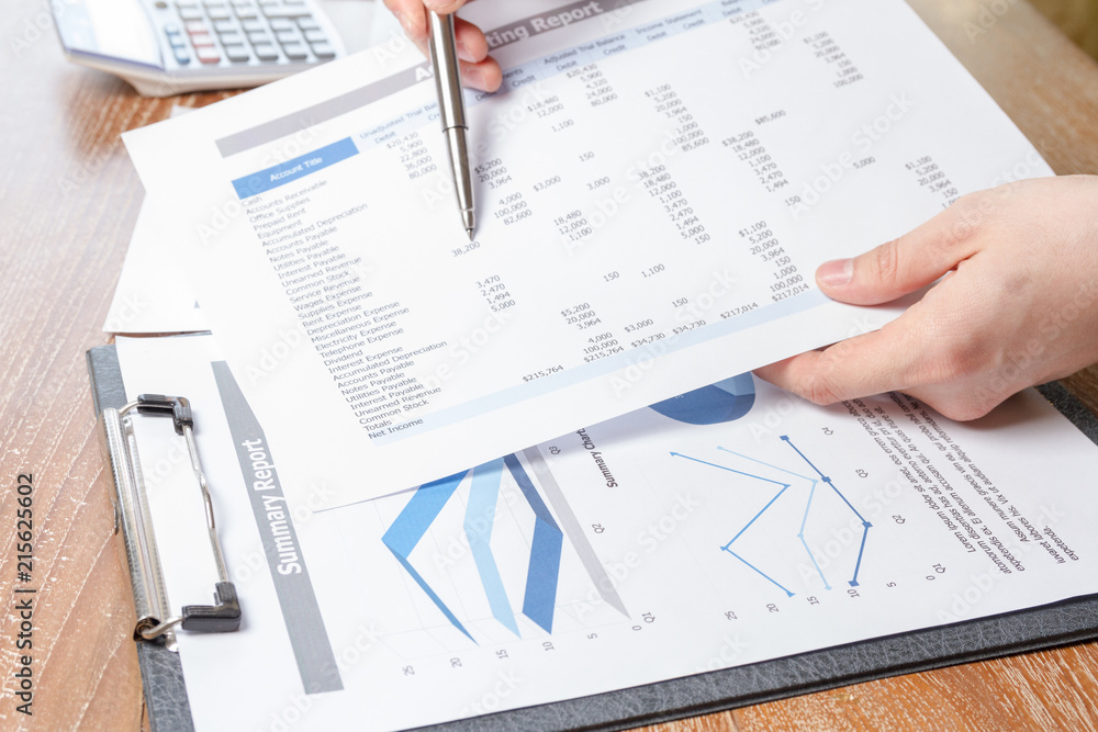 business man analyzing graph and chart document report business man analyzing graph and chart document report