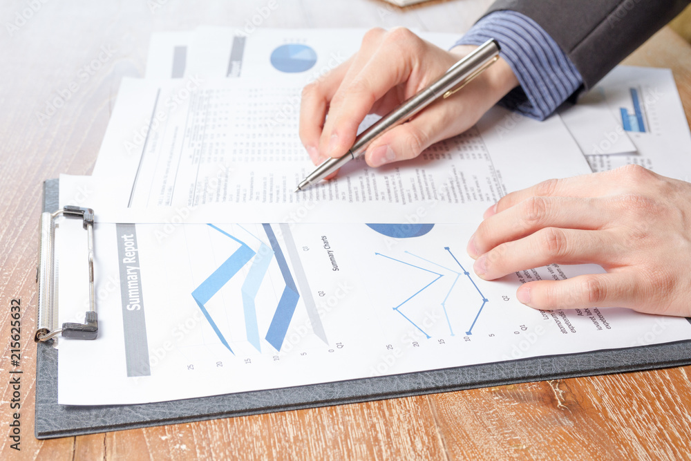 business man analyzing graph and chart document report Stock Photo ...