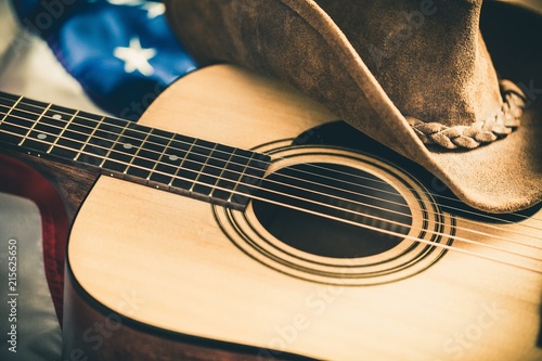 Foto Acoustic Guitar and Cowboy Hat with American Flag on Background