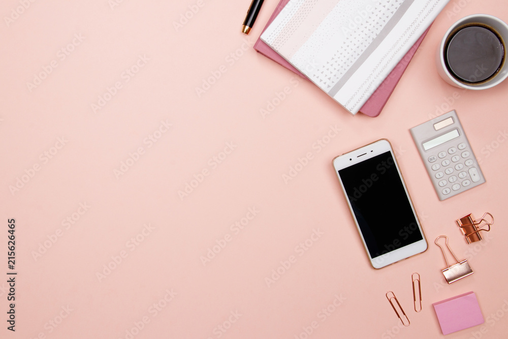 Office table desk with smartphone and other office supplies on pink background. Top view with copy space, flat lay. Office table desk with smartphone and other office supplies on pink background. Top view with copy space, flat lay.