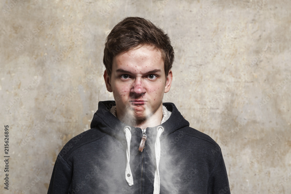 Studio portrait of a teenager boy.Emotions of a person, anger. Studio portrait of a teenager boy.Emotions of a person, anger.