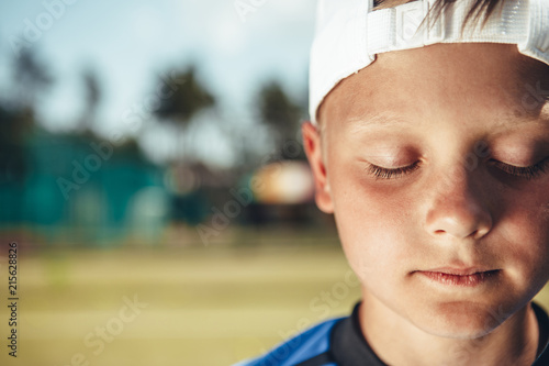 Close up face of small boy demonstrating quiet while locating outdoor. Copy space photo