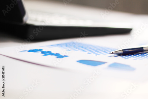 business background: financial chart and pen on office workplace © yurolaitsalbert