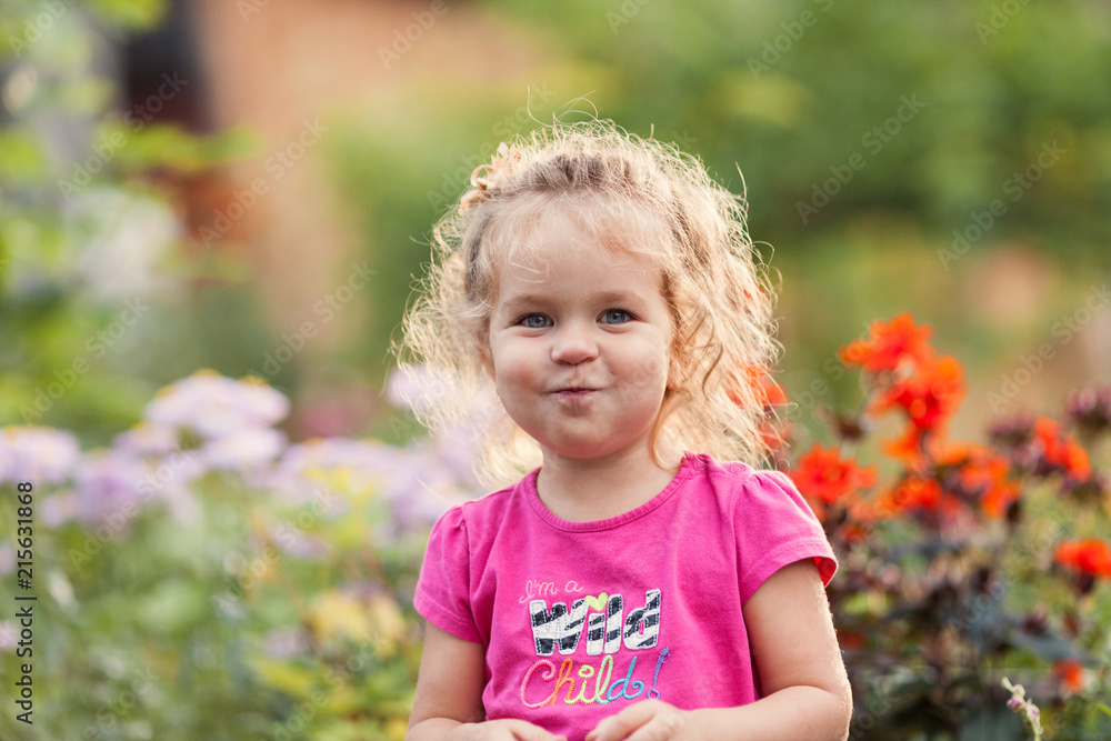 Portrait of cute little girl in summer garden Portrait of cute little girl in summer garden