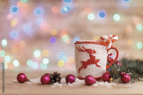 Cup for tea or coffee with Christmas knitted ornaments and Chris