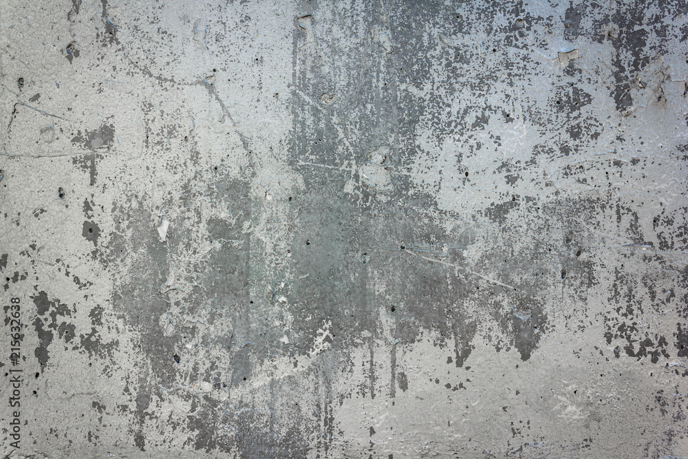 Gray concrete wall with peeling paint. Texture and background