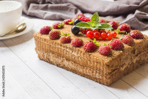 Honey cake with strawberries, mint and currants.