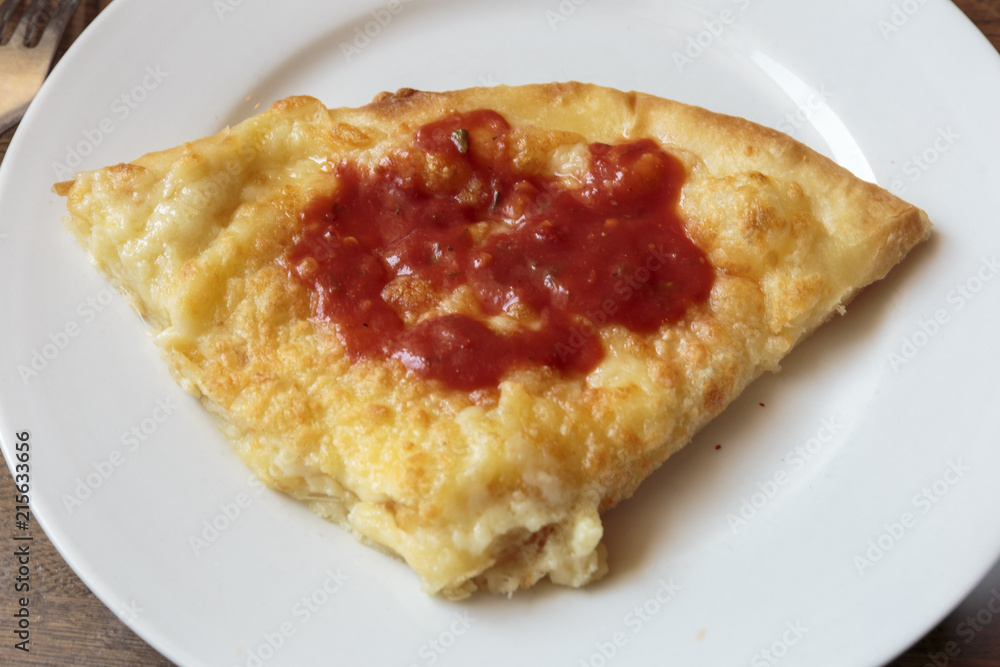 Slice of fresh cheese pizza with spicy ketchup. Italian traditional appetizer. Slice of fresh cheese pizza with spicy ketchup. Italian traditional appetizer.