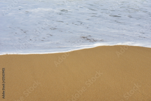 Fototapeta Naklejka Na Ścianę i Meble -  White Sea wave and sandy beach Background.Copy space