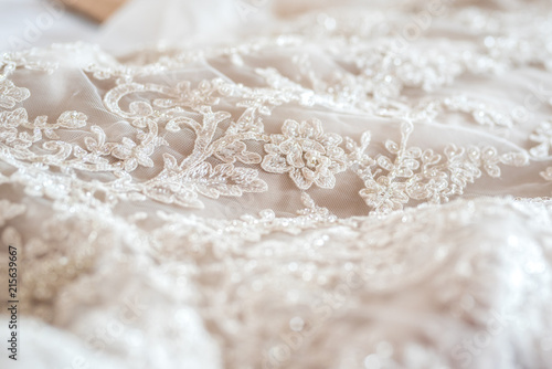 Obraz na plátně Wedding dress close up - white lace with floral pattern