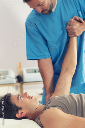 Physiotherapist Working With Patient Arm