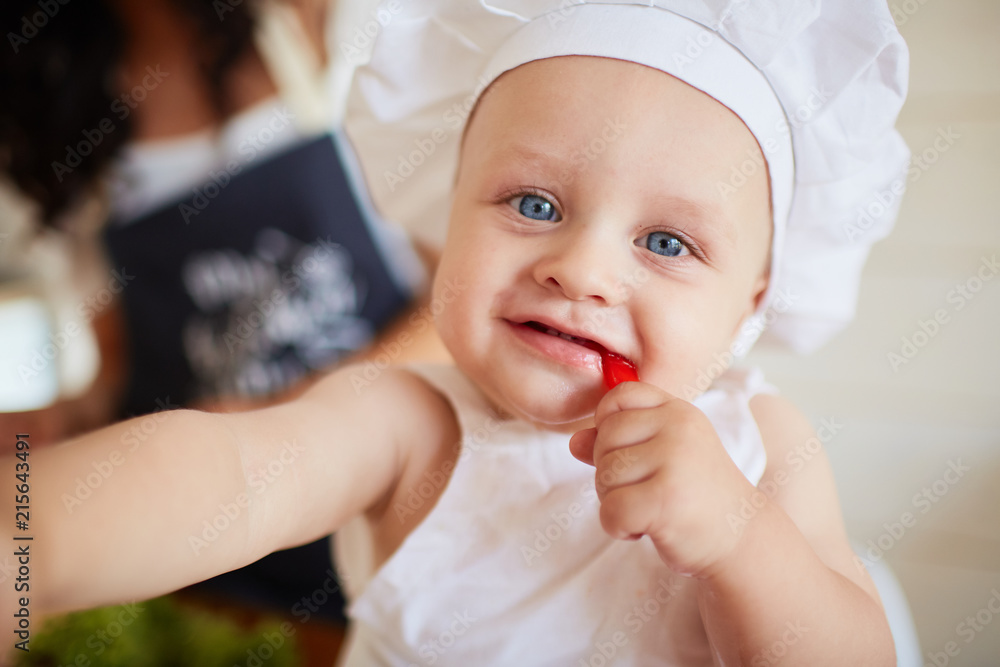 The pretty baby eatting a red paper The pretty baby eatting a red paper