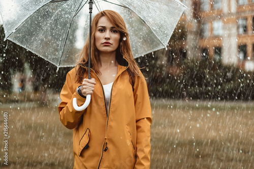 Εκτύπωση καμβά Waist up portrait of unhappy girl holding umbrella in hands