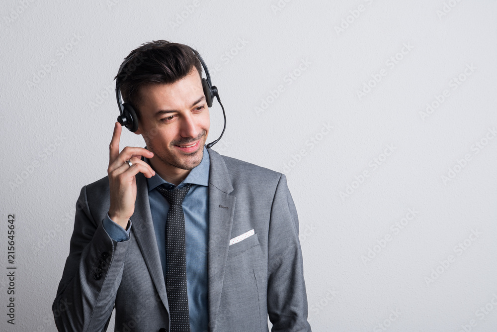 Portrait of a young man with headset in a studio. Copy space. Portrait of a young man with headset in a studio. Copy space.