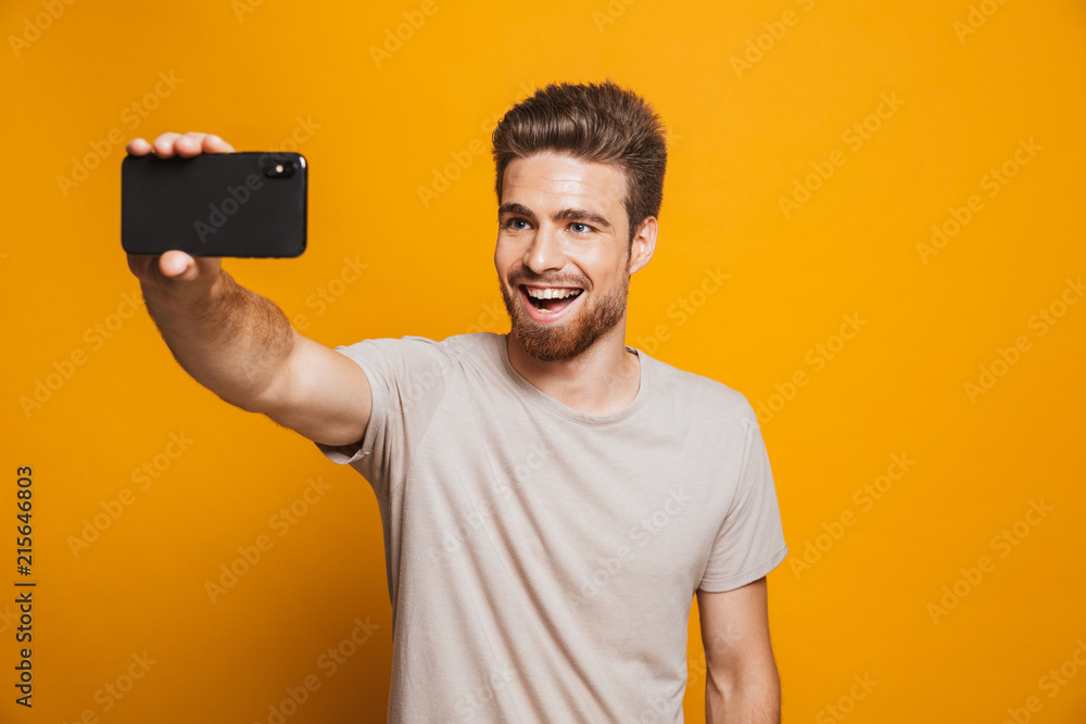Portrait of a happy young man taking a selfie Portrait of a happy young man taking a selfie