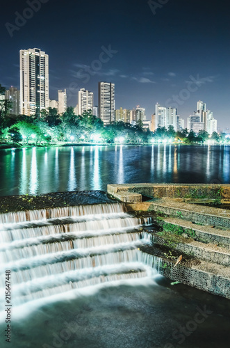 Photo of the Lago Igapo, Londrina - Parana, Brazil. View of the Igapo lake at night, the artificial waterfalls and the city, buildings on background. Leisure place, touristic destination of the city.