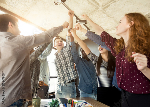 Schilderij op canvas Young business team enjoying success at office