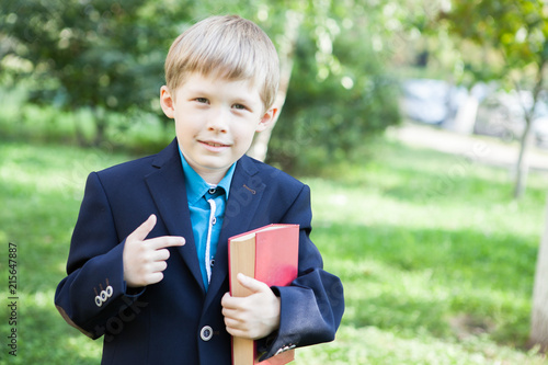 Wallpaper Mural A boy with a book in his hand. The boy is reading a book in the open air. The boy is holding a book. Torontodigital.ca