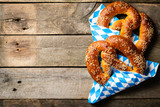Oktoberfest concept - pretzels on rustic wood background