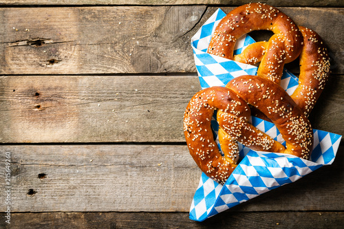 Obraz na plátně Oktoberfest concept - pretzels on rustic wood background