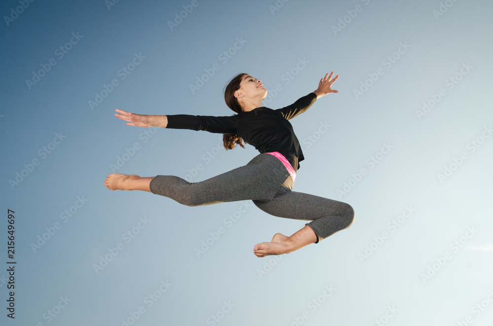 Fototapeta Gymnast girl jumping