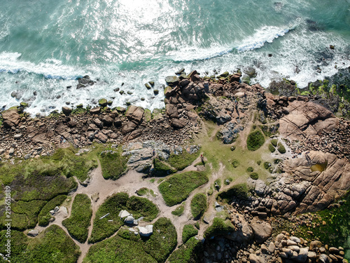  Aerial view of green islands on Brazilian beach with white sand and blue sea.