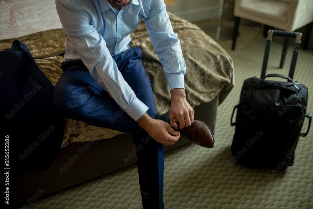 Businessman tying shoes laces