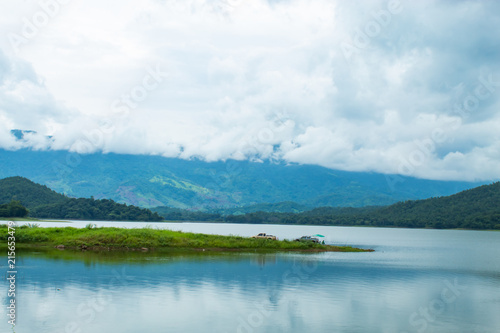 Fishermen sit fishing at the Huai Pa Daeng Reservoir , Phetchabun in Thailand.