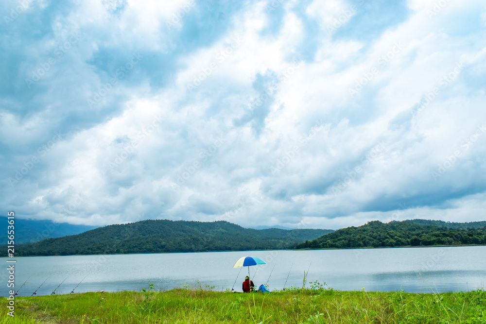 Fishermen sit fishing at the Huai Pa Daeng Reservoir , Phetchabun in Thailand. Fishermen sit fishing at the Huai Pa Daeng Reservoir , Phetchabun in Thailand.