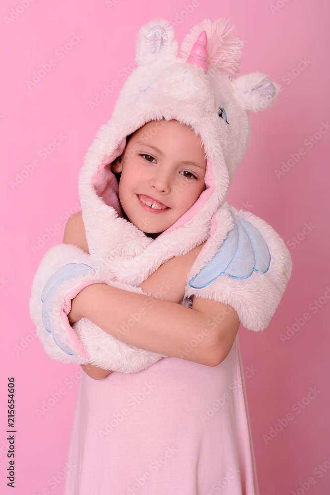 Smiling caucasian beautiful little girl in a hat with unikorn Smiling caucasian beautiful little girl in a hat with unikorn