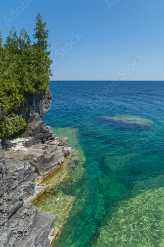 Lake Huron shoreline blue green water and limestone rocks along the Georgian bay lake shore landscape