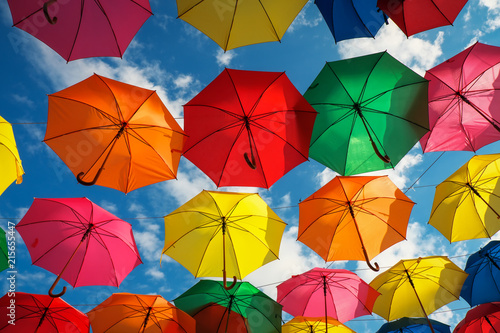 Lots of colorful umbrellas in the sky. City decoration photo