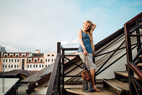 Portrait of a beautiful blond young Caucasian girl outdoors. Portrait of young smiling woman outdoors. Soft sunny colors. Closed portrait. © Pavel