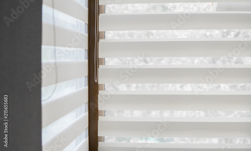 Canvas Print Details of white fabric roller blinds on the plastic window with wood texture in the living room