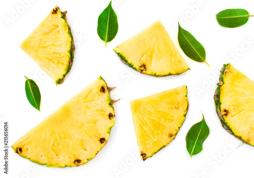 Sliced pineapple and green leaves pattern. Tropical pineapple summer fruit isolated on white background. Top view.