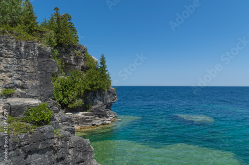 Lake Huron shoreline blue green water and limestone rocks along the Georgian bay lake shore landscape