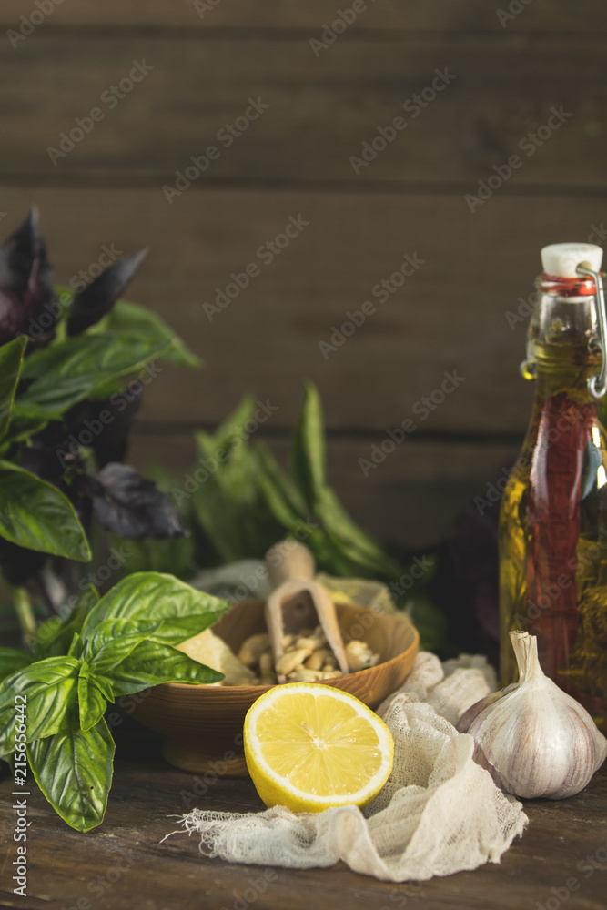 Many food ingredients for making pesto on dark wooden background Many food ingredients for making pesto on dark wooden background