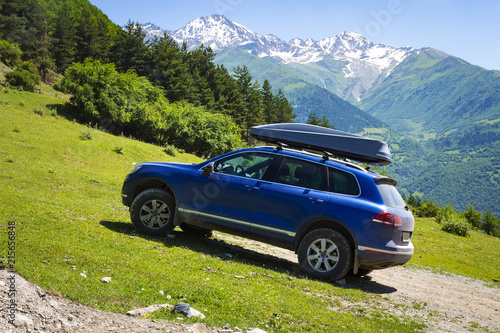 Obraz na płótnie Car in mountains. Car is an off-road car in mountain on clear, sunny summer day. Travel by car through the wild. trip to the mountains by car. Amazing landscape of mountains in Svaneti, Georgia. w salonie