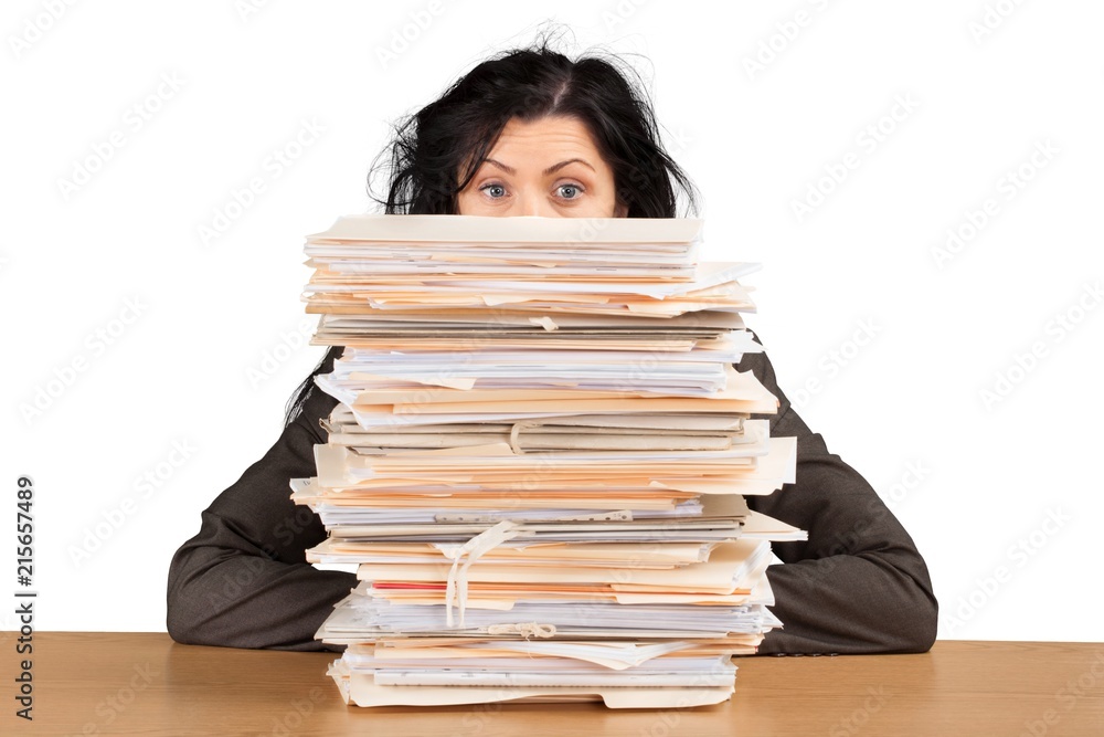 Businesswoman sitting at the table with many papers on Businesswoman sitting at the table with many papers on