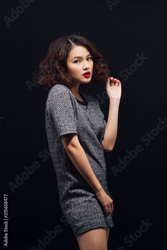 Attractive young asian woman in a black dress. Stylish girl model.