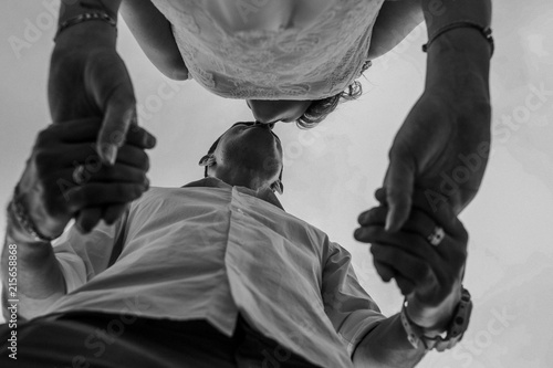 loving couple kissing holding hands view below © yuriy