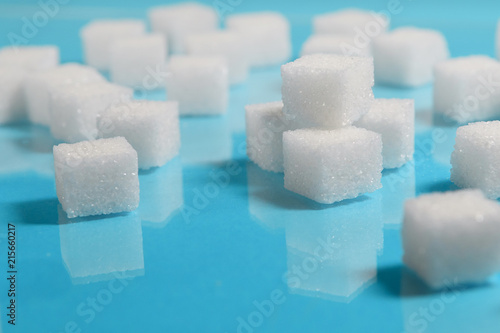 Group of Sugar cubes vary position on light blue background