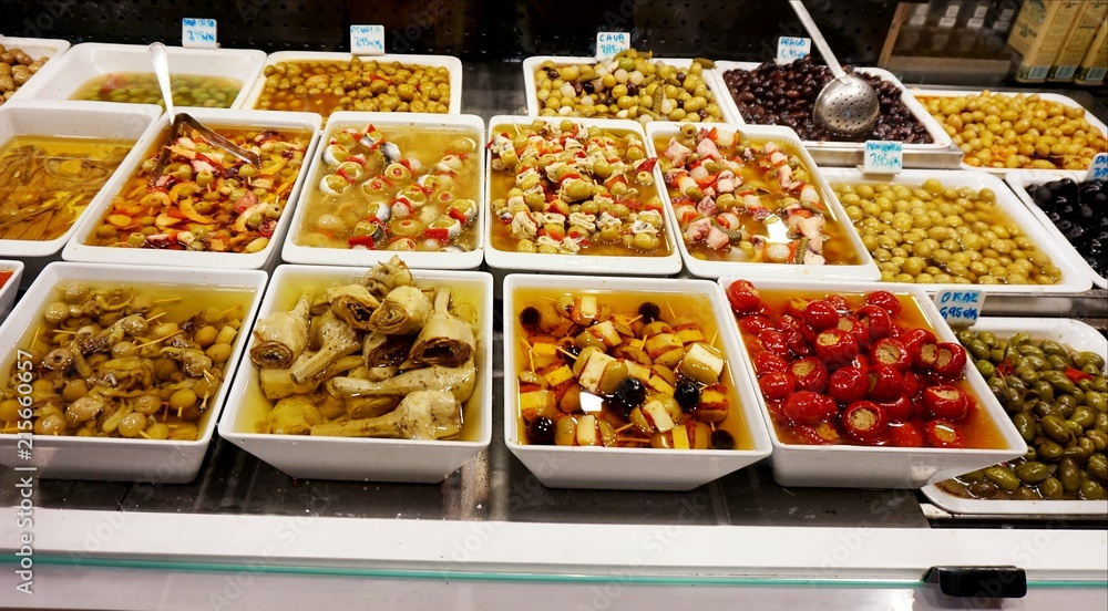 Sale of food in plastic plates in the Boqueria market in Barcelona.