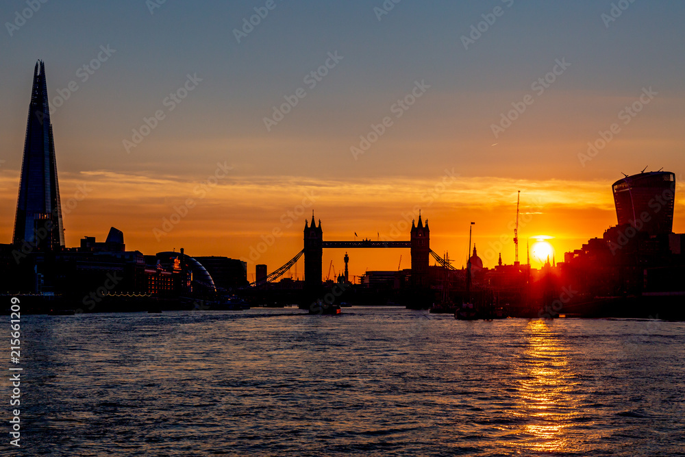 SIlhouetted buildings along the River Thames in London, at sunset